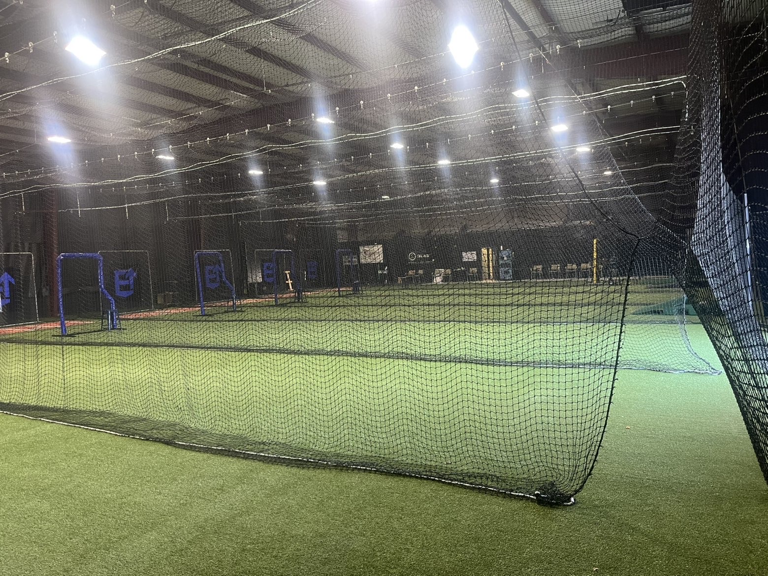 Wide view of the indoor netted batting cages